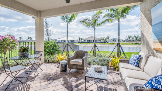 Luxury outdoor living space with Maybach-inspired sunglasses resting on a modern patio table