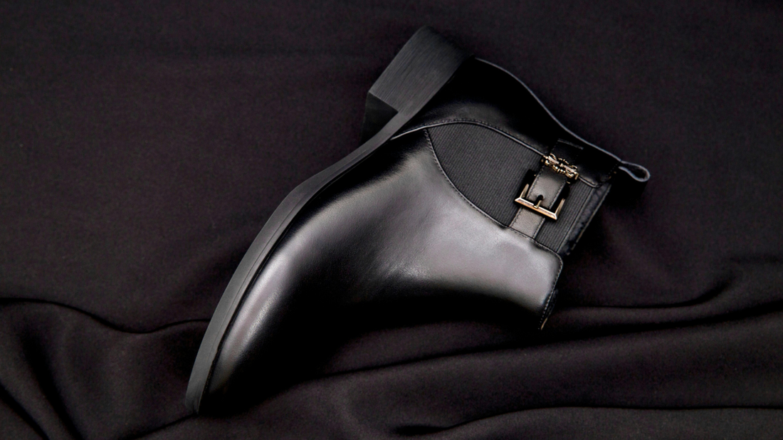 Clean, minimalist shot of your black leather Chelsea boots on a neutral background with good lighting.